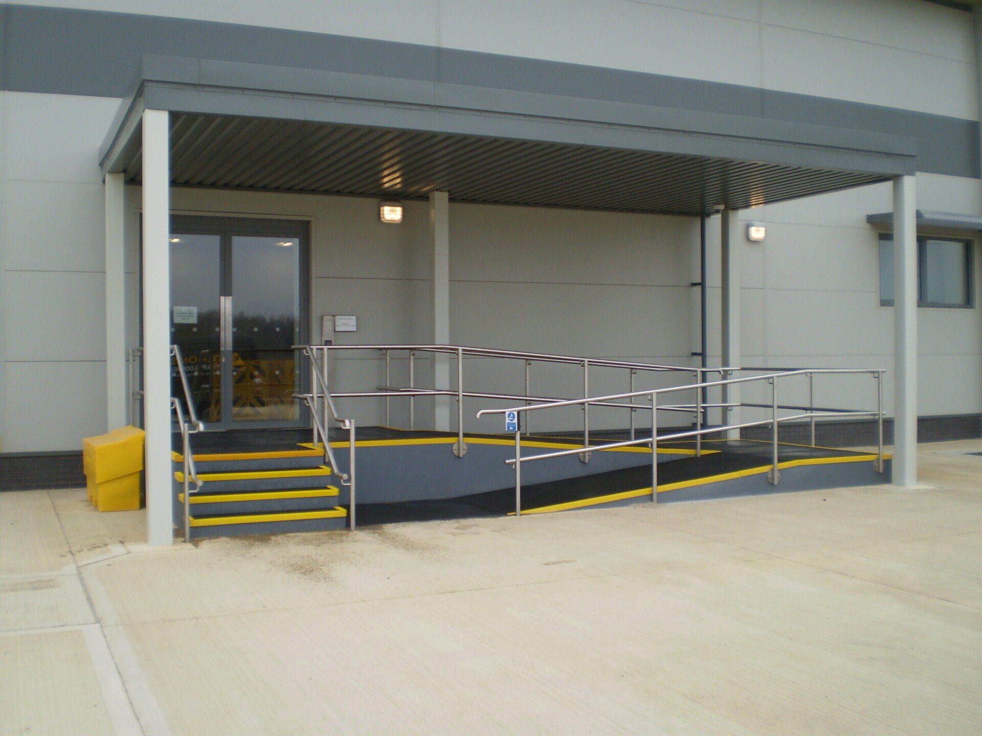 Stairs and a disabled access ramp with QuartzGrip GRP stair tread covers and flat plate
