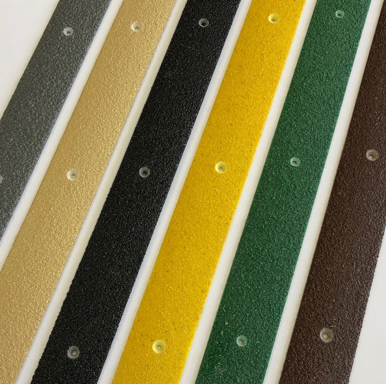 Step on Safety's Anti-Slip Decking strips in grey, beige, black, yellow, green and brown