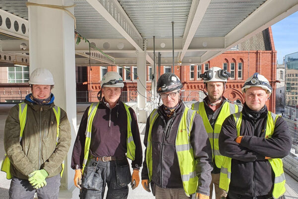 One of the Step on Safety installation teams onsite. All wearing hi-vis vests, hard hats and safety gloves