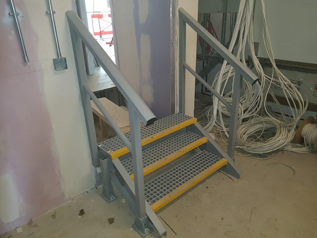 Small access staircase leading to a new doorway