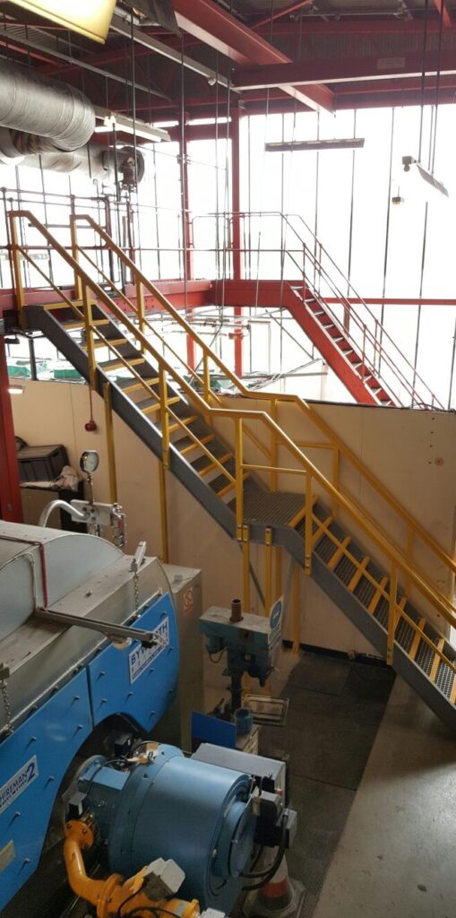 Multi-storey access staircase going up to a mezzanine floor in the plant room at Colchester Hospital