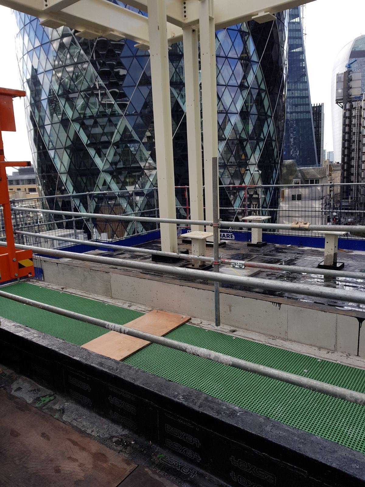 Green GRP open mesh grating used to make RiserDeck riser floors at a high-rise development in Bishops Gate, London