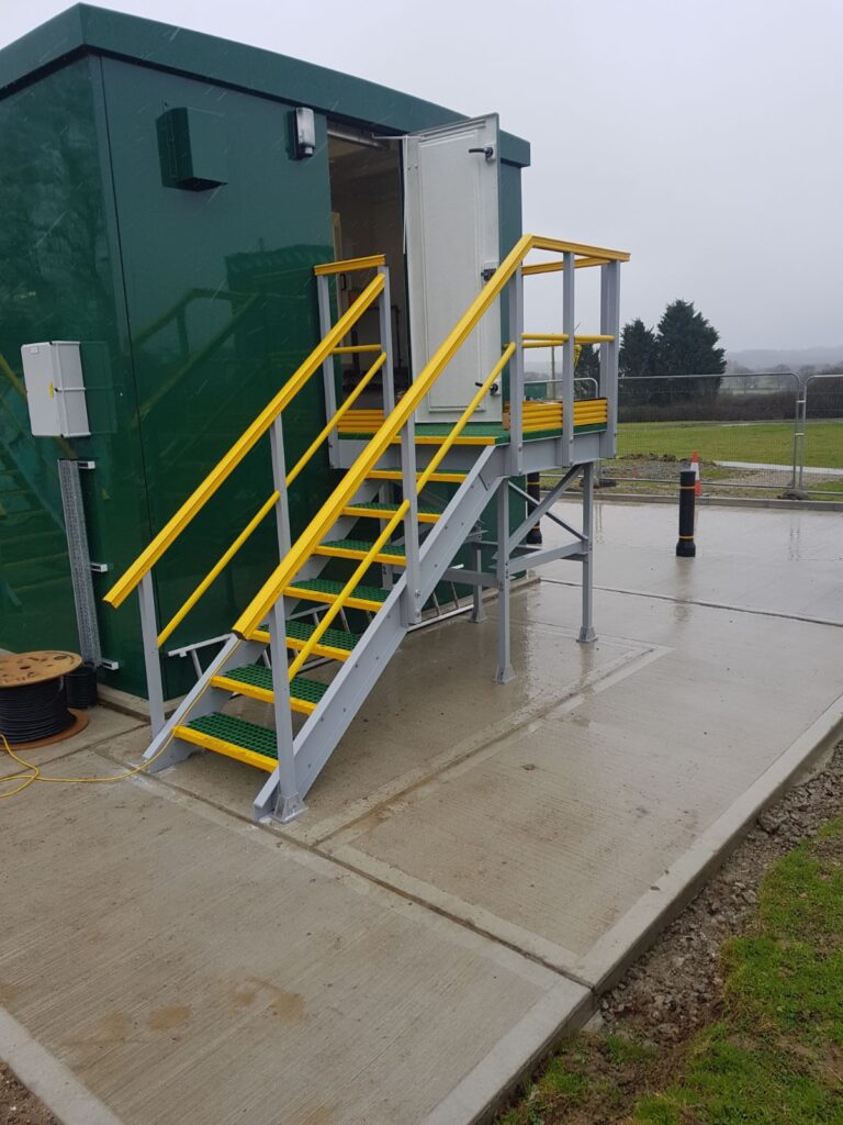 GRP access staircase and platform constructed from GRP profile, handrails and open mesh grating