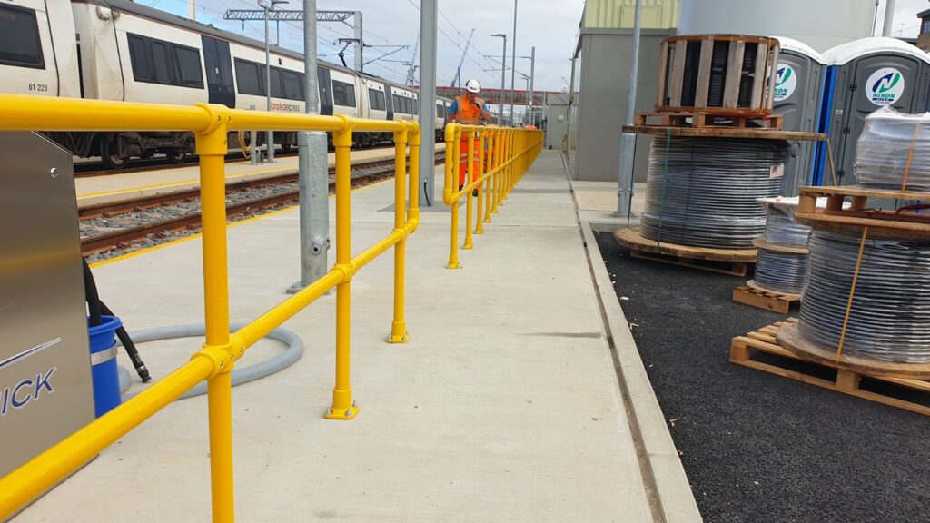 Photo looking along a GRP handrail at a railway depot in Cambridge