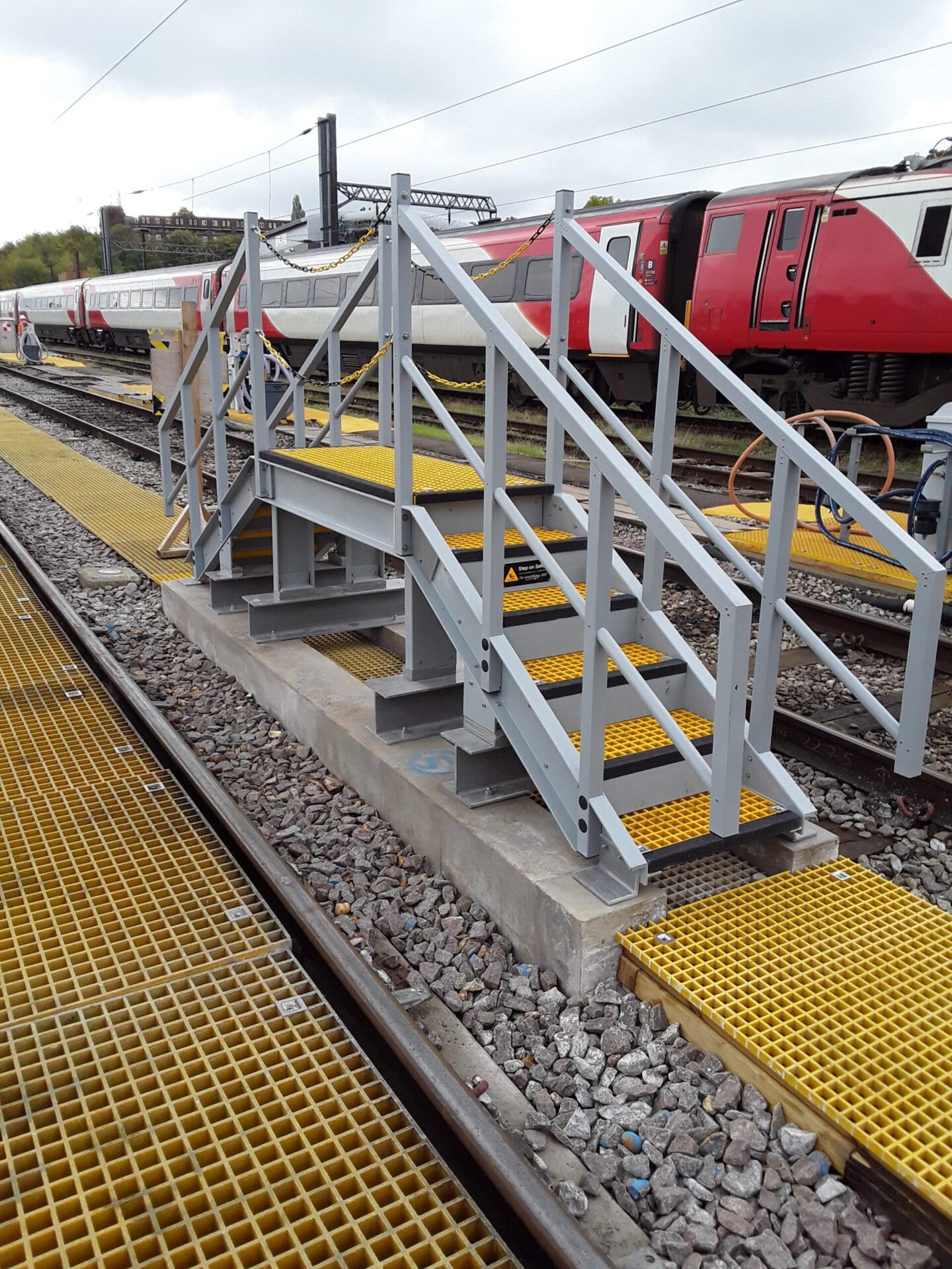 GRP Industry Solutions. Newly installed drivers access platform between two railway tracks at Ferme Park