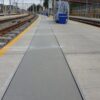 Photo shows a GRP solid top trench cover running the length of a railway depot