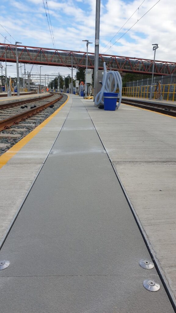 Photo shows a GRP solid top trough cover running the length of a railway depot