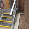 Small GRP access staircase and platform constructed from GRP profile, handrails and open mesh grating