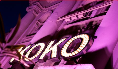 A night time shot of the frontage of KOKO in Camden flooded with purple light