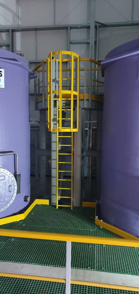 Access platform and bund floor at whitehillocks water treatment works. Steps and floor are made using QuartzGrip GRP standard open mesh panels in green. Hellow stair nosing, handrails and kickplate highlight the hazardous areas