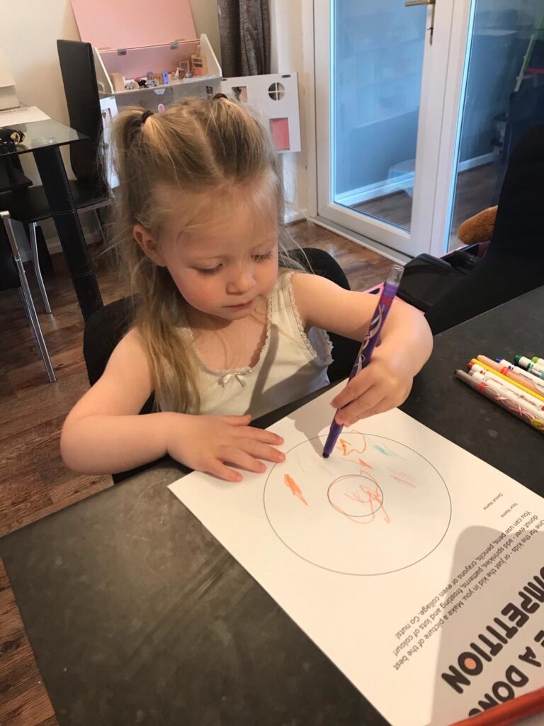 Little girl colouring a donut