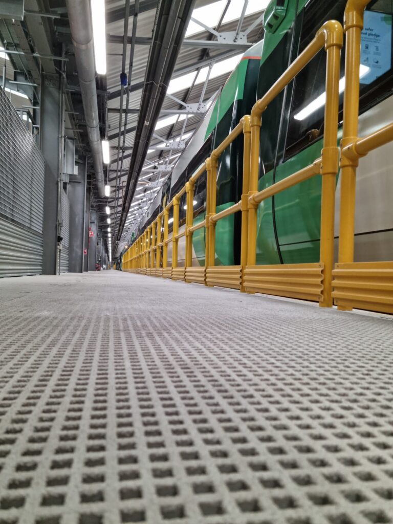 Grating and Handrail close up next to a train at Selhurst Depot