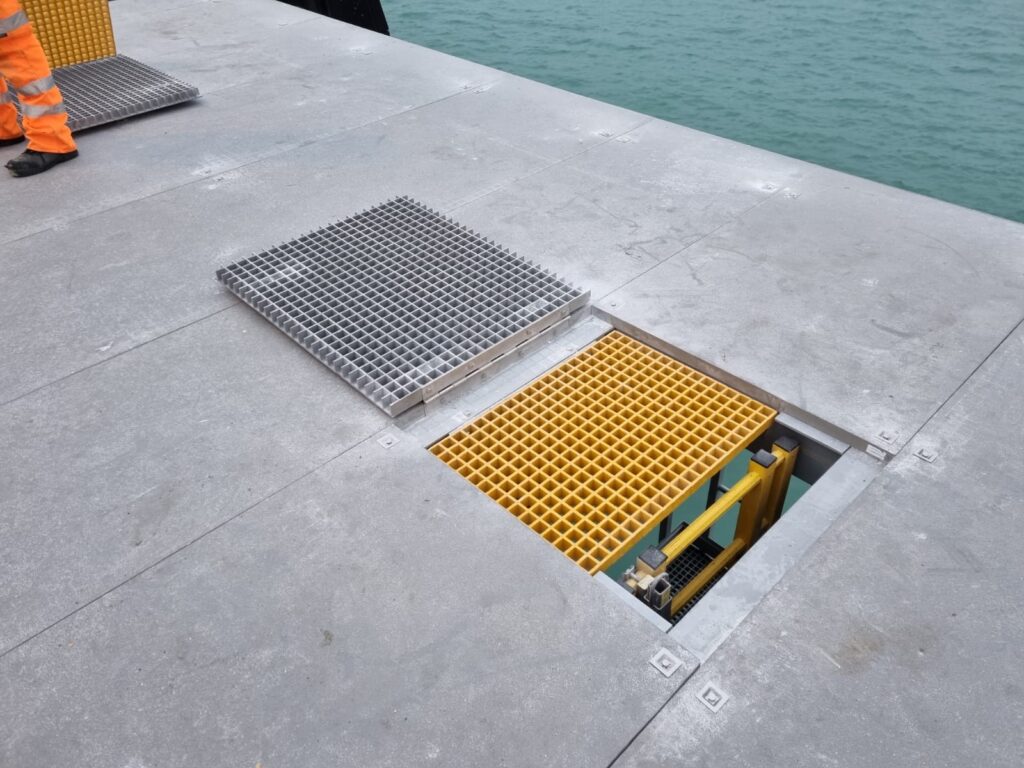 Fall Arrest Manhole cover open to show the open mesh inspection cover