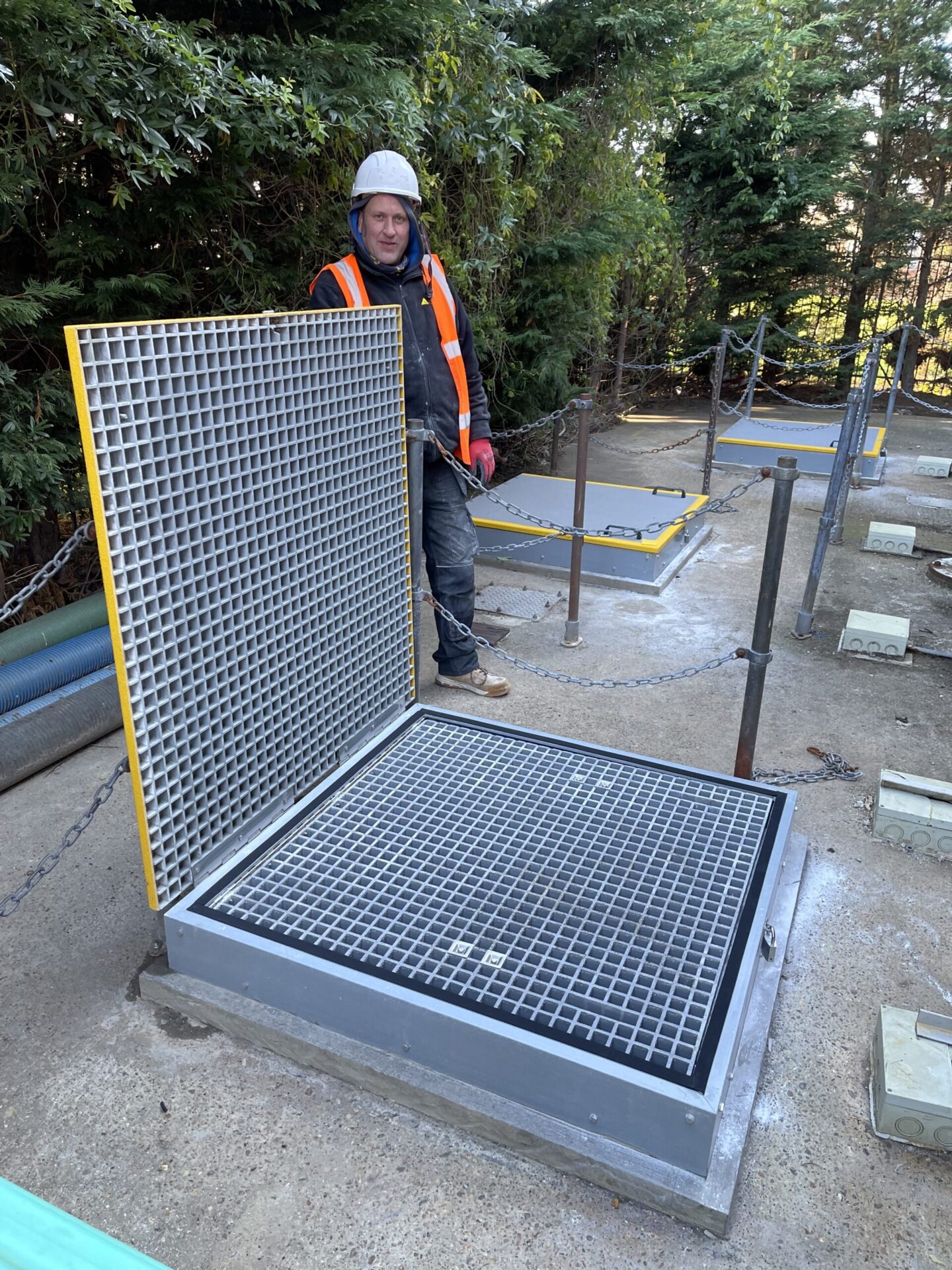 Large Fall Arrest Manhole cover open to show the open mesh inspection cover