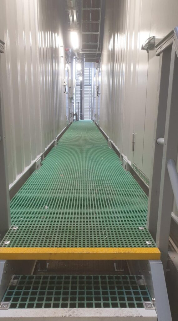 A long, raised access walkway at a data centre in Slough